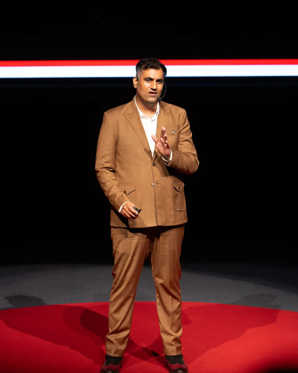 Ar. Vishwas Chadha delivering his TEDx talk from the red-circle stage